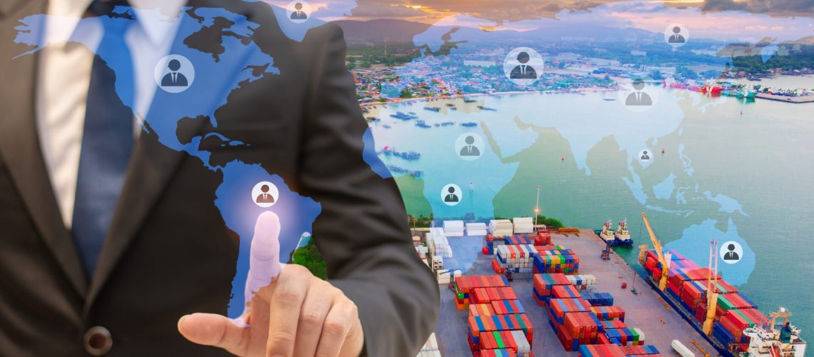 Businessman touching icon people on earth world map for network connection,on Logistics and transportation of International Container Cargo ship in the ocean background,Transportation, Shipping.